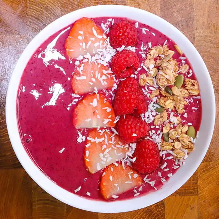 mixed berry smoothie bowl with strawberries raspberrys and granola