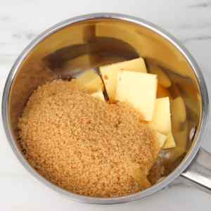 Brown sugar and butter in a saucepan, ready for caramel sauce preparation.