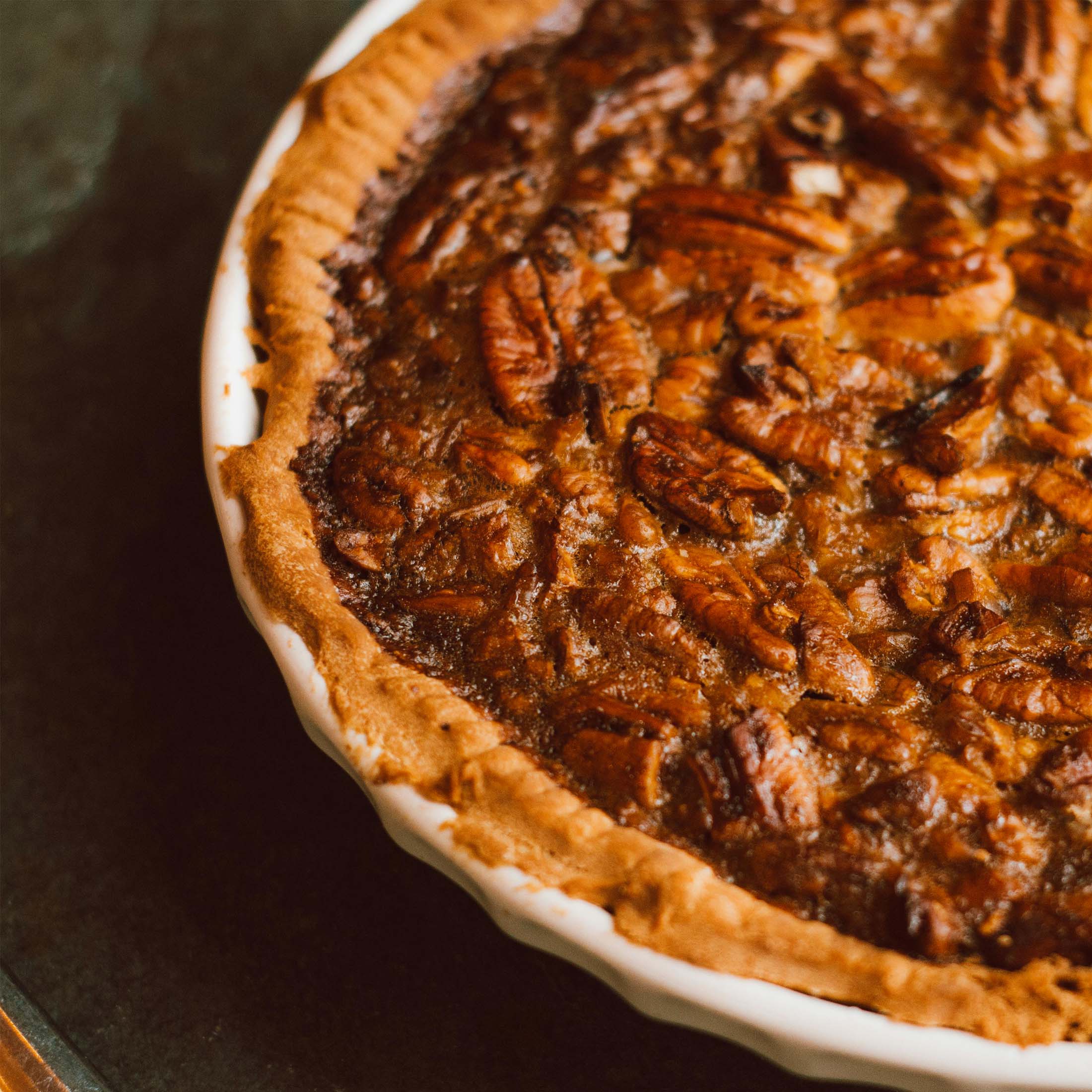 Pecan-pie-2000-01 A close-up of a pecan pie with a golden crust and a rich, nutty filling.