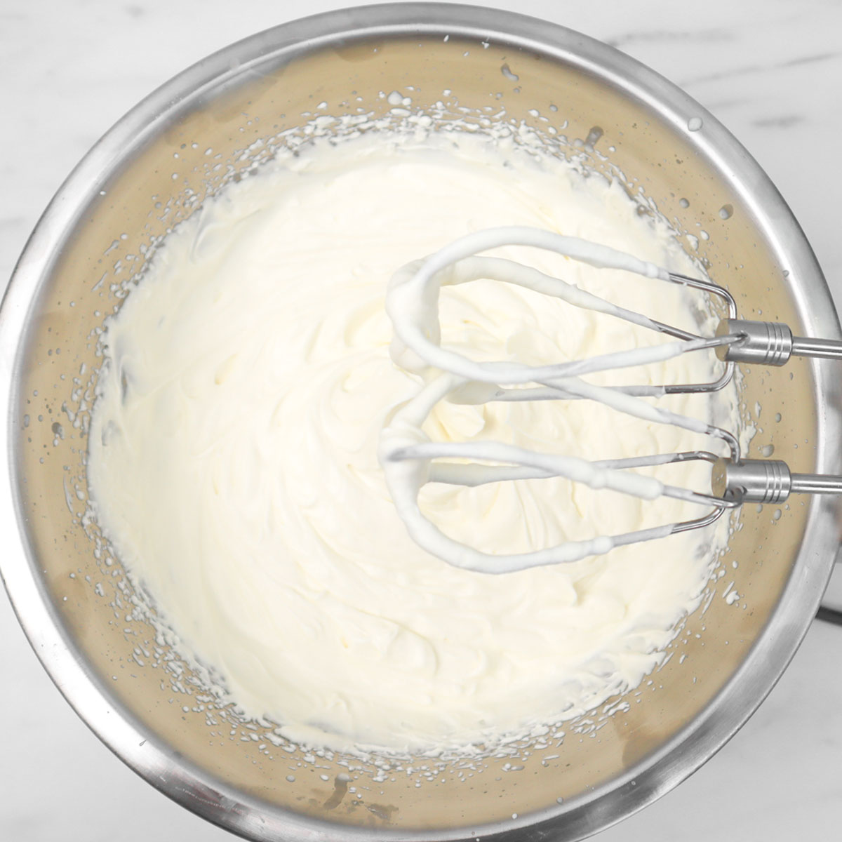 Chocolate Chip Cookie Dough Ice Cream A mixing bowl with whipped cream and beaters, ready for making ice cream.
