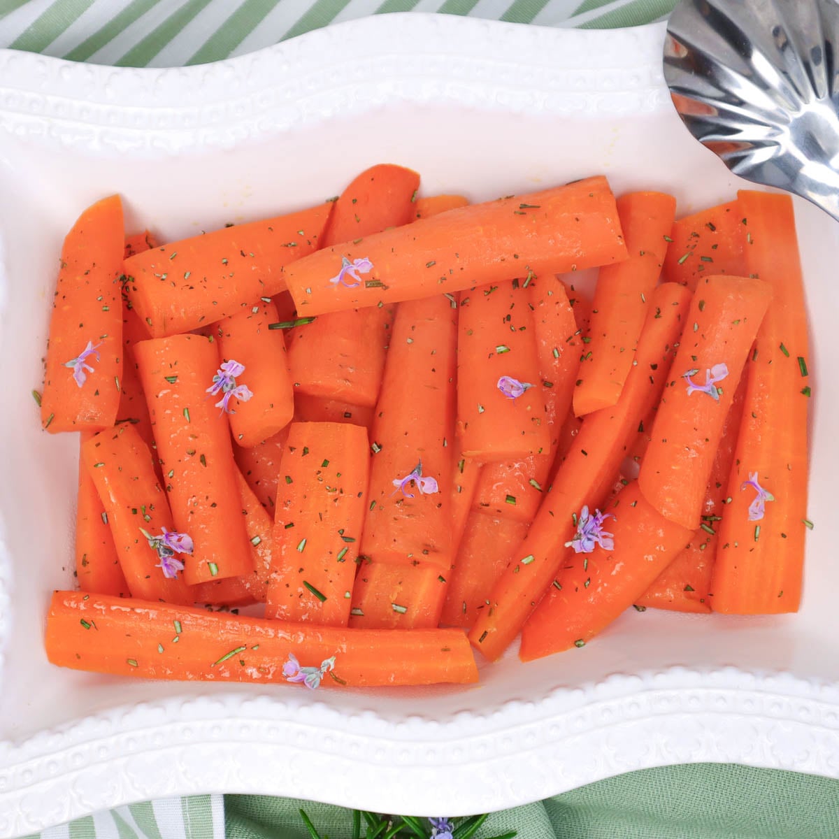 Honey roasted carrots in a white serving dish