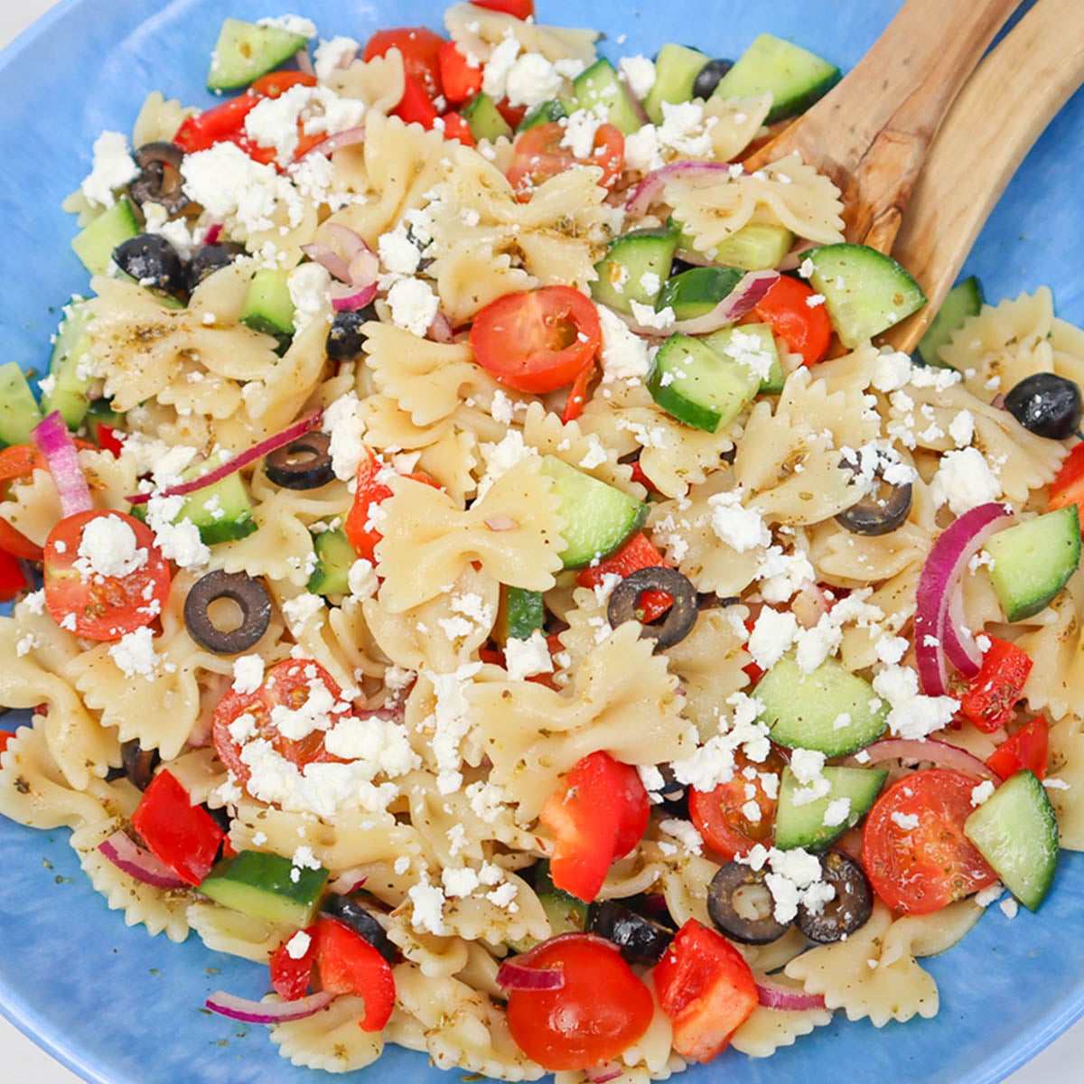 Mediterranean Pasta Salad A colorful Mediterranean pasta salad with farfalle, cherry tomatoes, cucumbers, olives, and feta cheese.