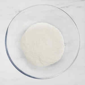 A bowl filled with flour, ready for making pink breakfast waffles.