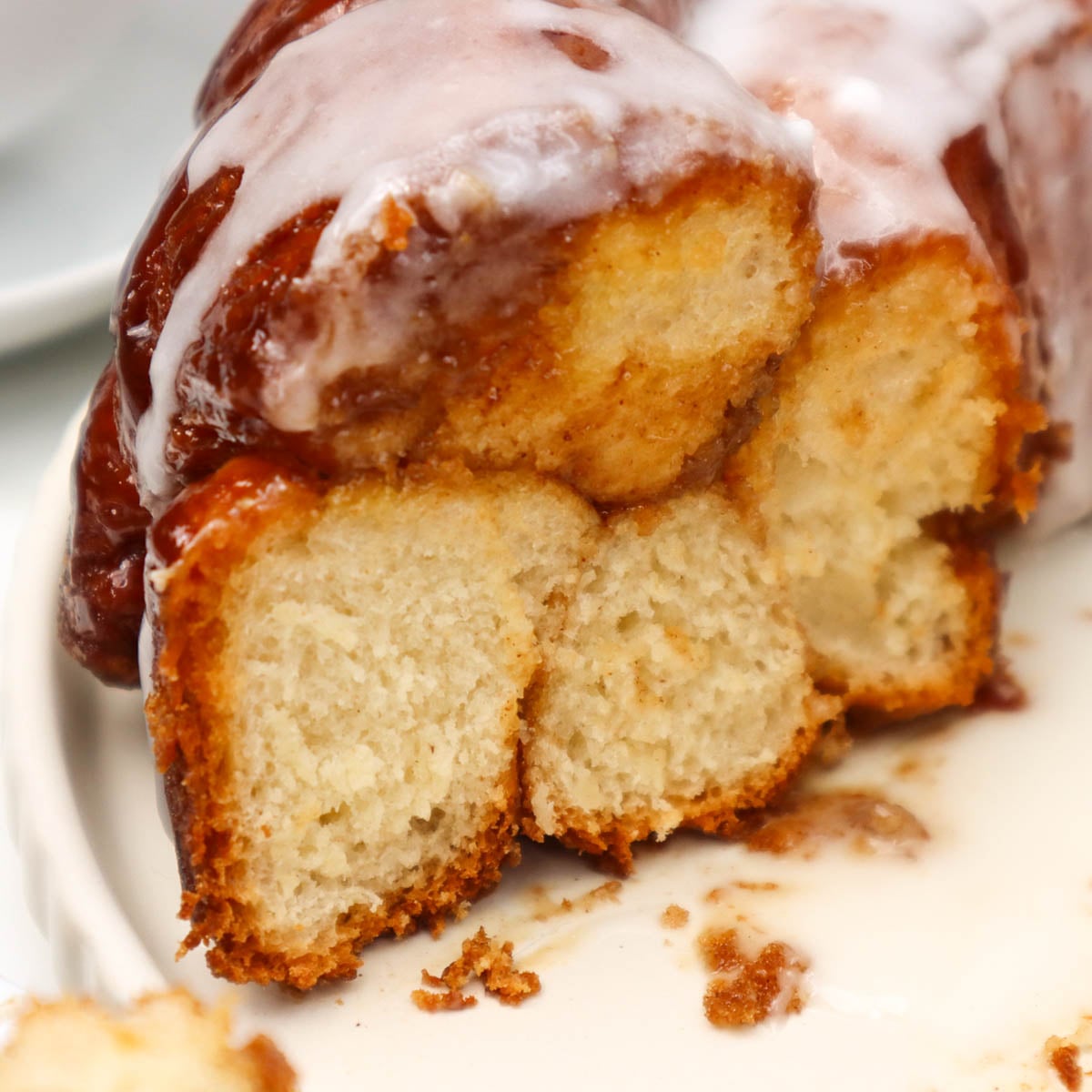 Pull Apart Monkey Bread Close-up of a slice of pull-apart monkey bread with a glaze on top.