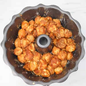A close-up view of pull-apart monkey bread in a bundt pan, coated with cinnamon and sugar.