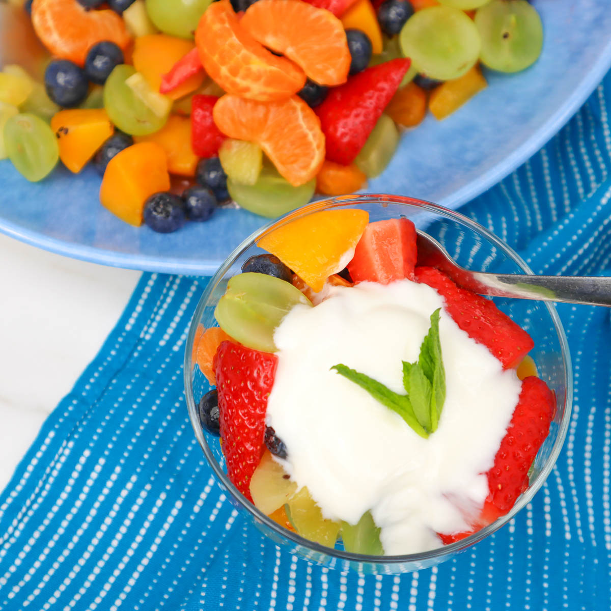 Summer Fruit Salad A colorful summer fruit salad with strawberries, blueberries, and yogurt, served in a glass bowl.
