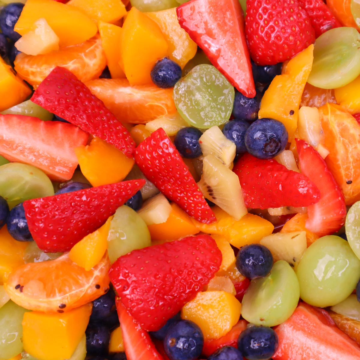 Summer Fruit Salad A colorful mix of fresh summer fruits, including strawberries, blueberries, grapes, and mandarin oranges.