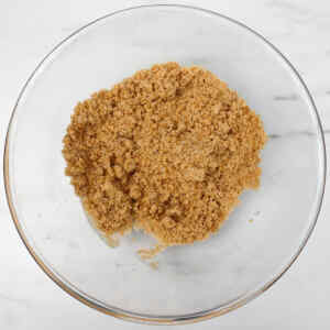 A bowl filled with brown sugar, ready for baking coffee cake muffins.