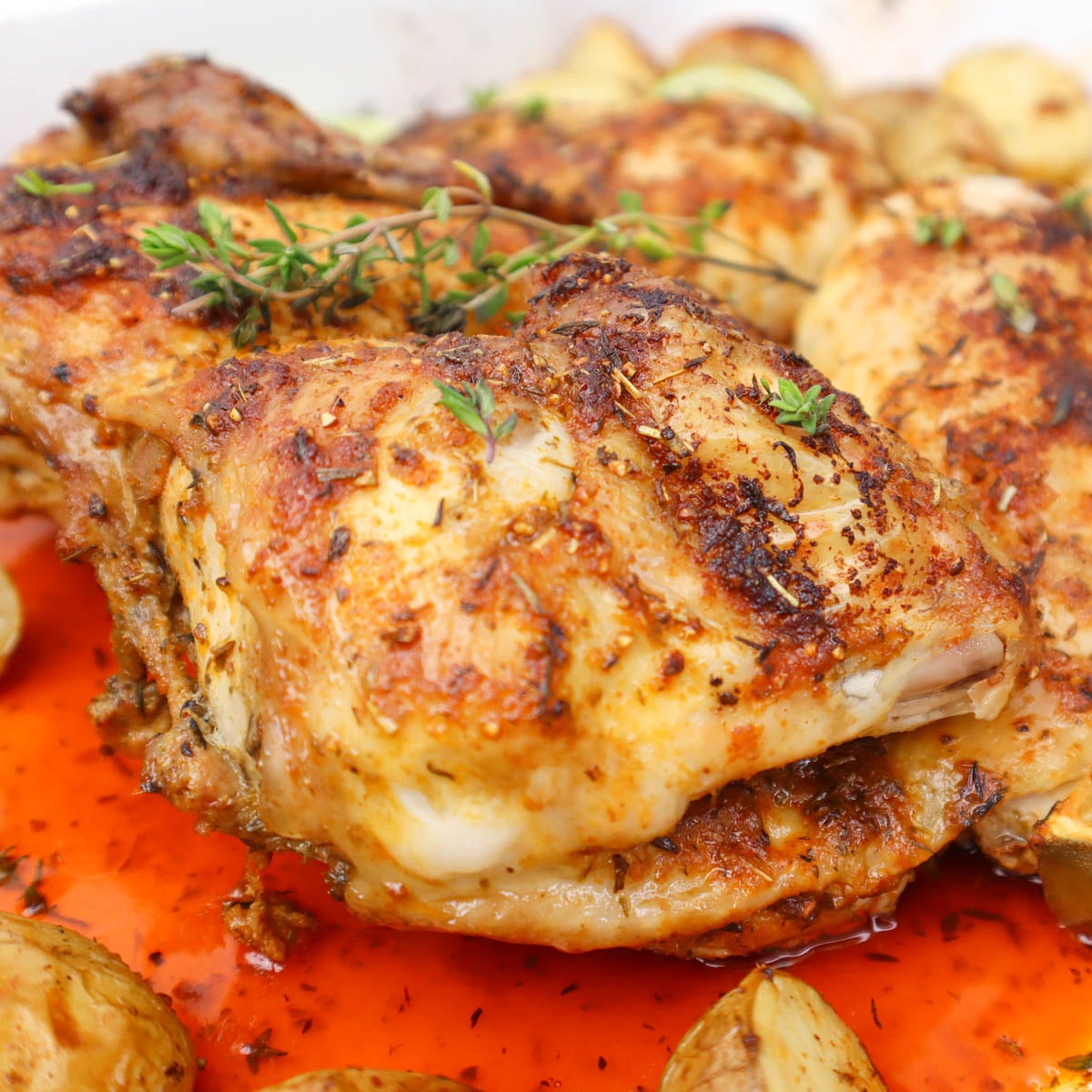 Frango aberto ao estilo mexicano Close-up de frango aberto em borboleta, temperado com ervas e especiarias, servido com batatas assadas.