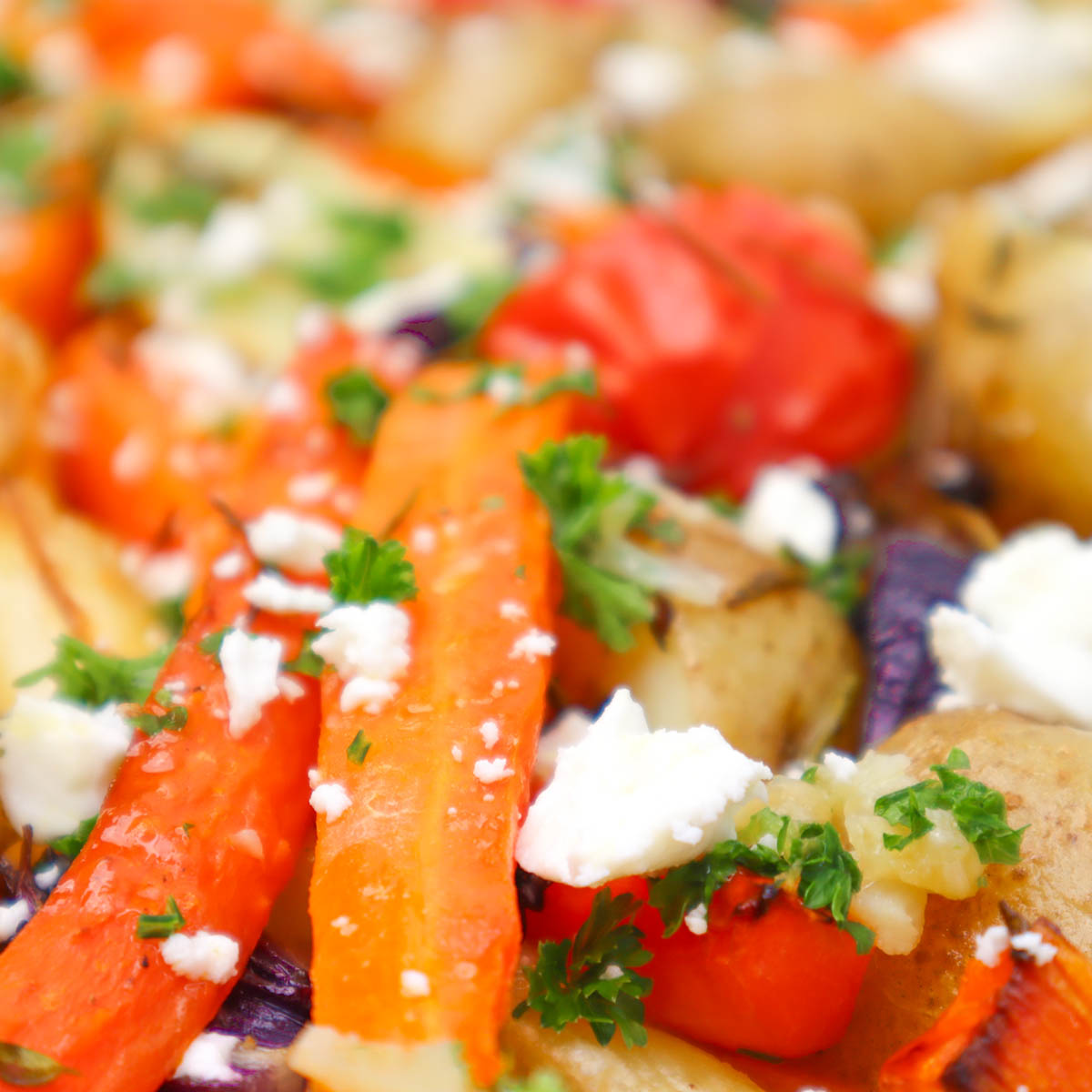Roasted Vegetable Tray Bake A colorful roasted vegetable tray bake featuring carrots, potatoes, and feta cheese.