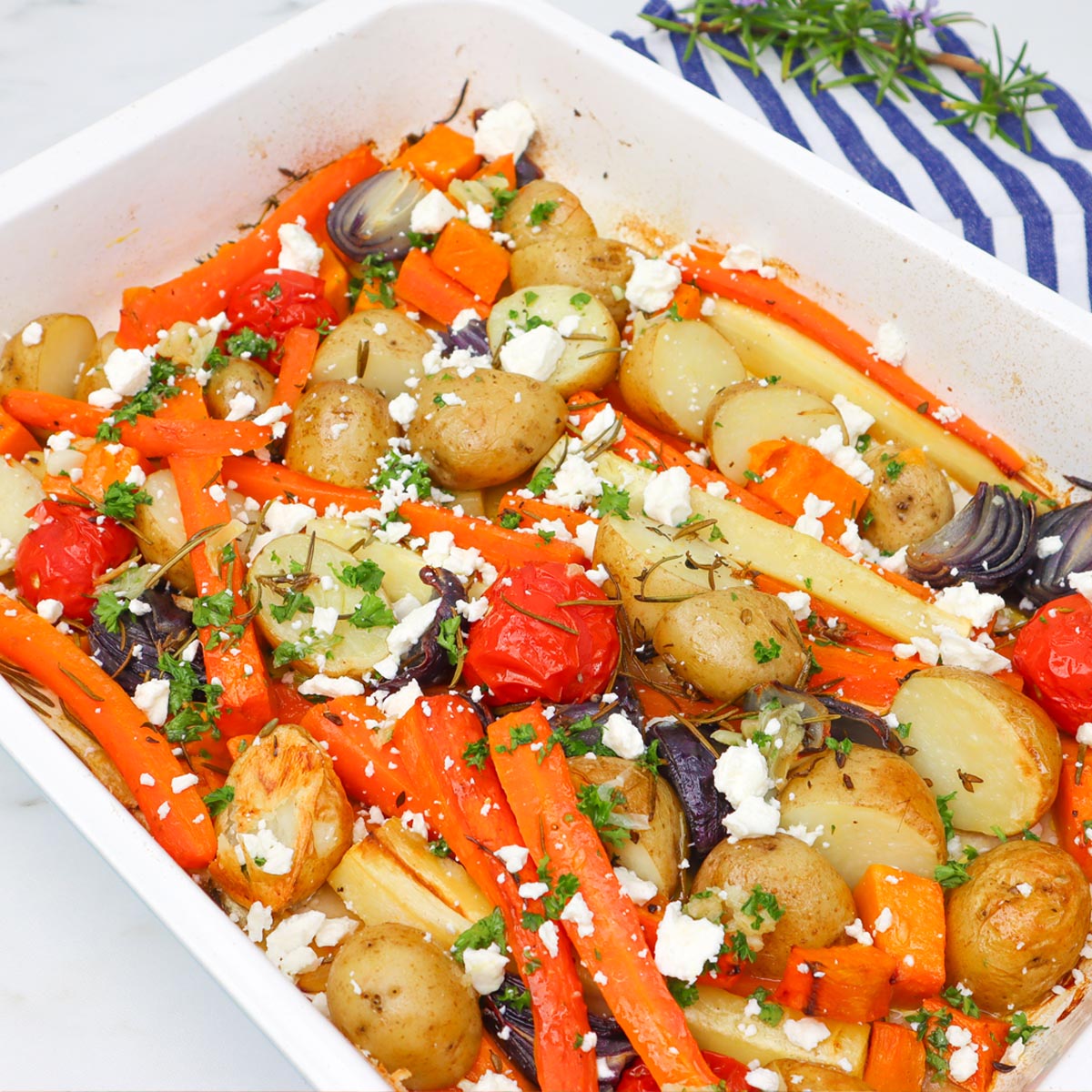 Roasted Vegetable Tray Bake A colorful roasted vegetable tray bake featuring carrots, potatoes, and feta cheese.