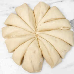 Dough shaped into a star pattern, ready for making burger buns.