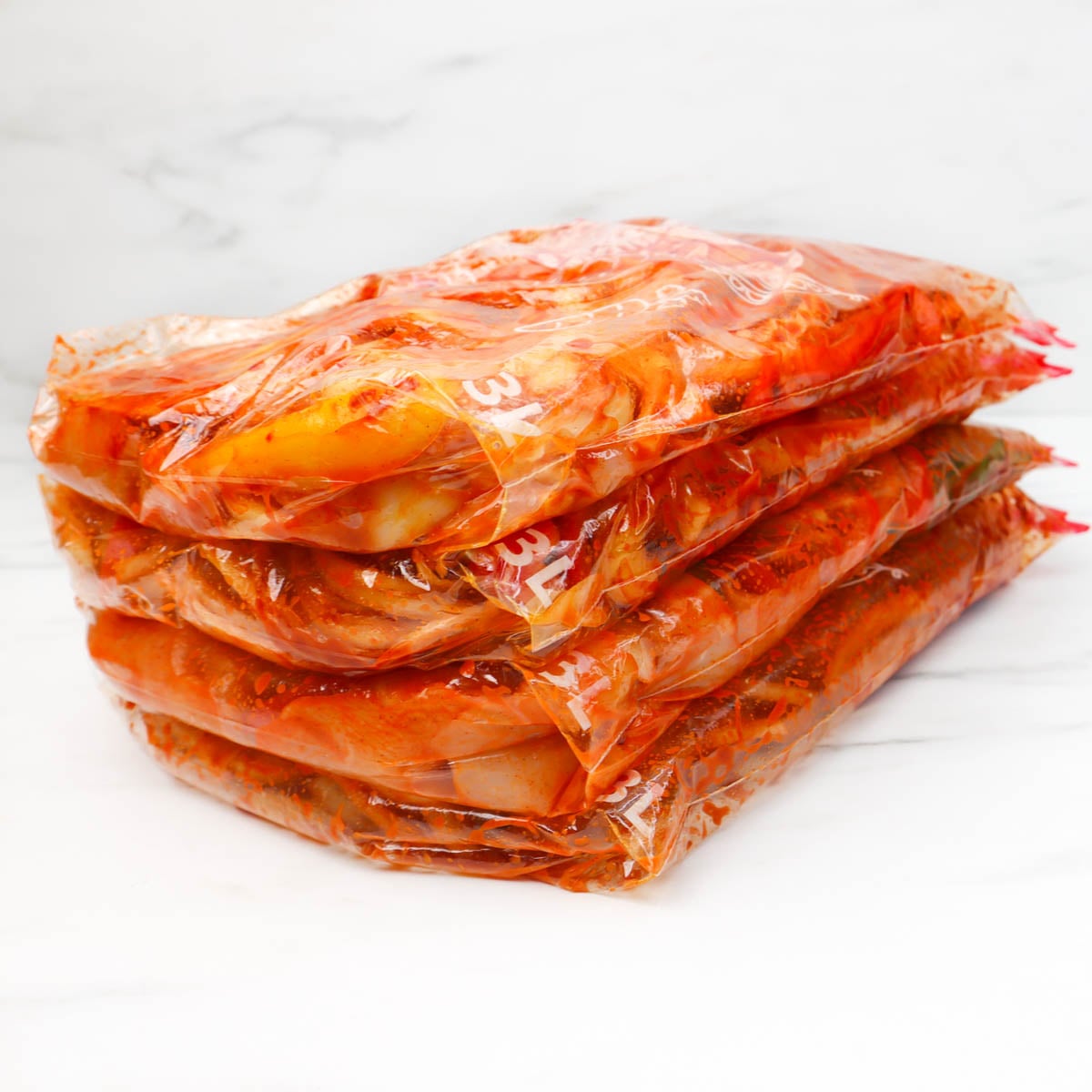 Chicken fajitas Freezer Meal Prep Four bags of marinated chicken fajitas stacked for freezer meal prep.