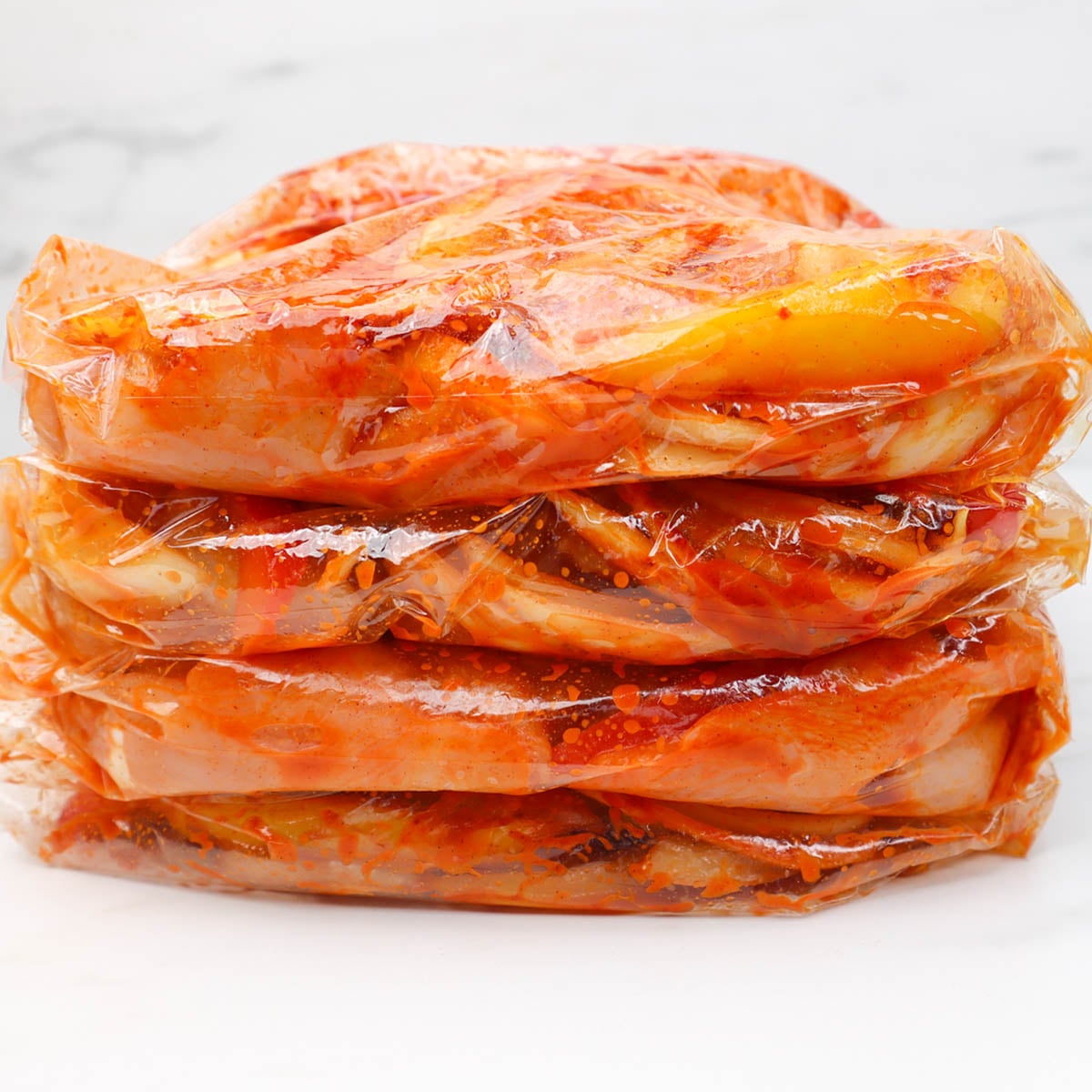 Chicken fajitas Freezer Meal Prep Four stacked bags of marinated chicken fajitas ready for freezer meal prep.