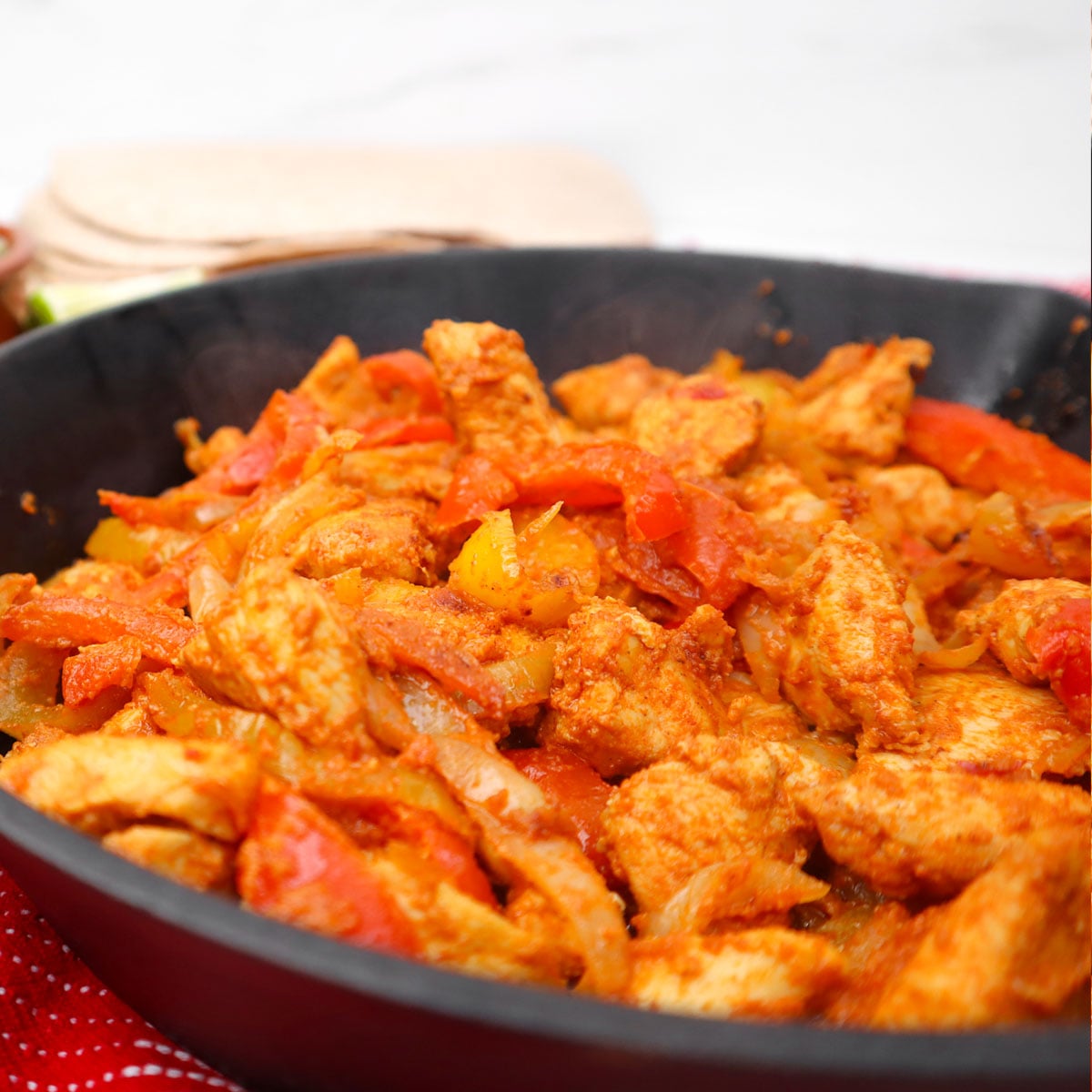 Chicken fajitas Freezer Meal Prep A skillet filled with seasoned chicken and colorful bell peppers for fajitas.