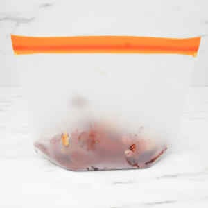 A clear freezer bag filled with a chocolate peanut butter smoothie mixture.