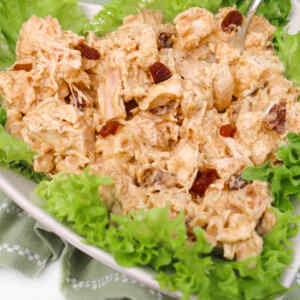 A serving of coronation chicken salad on a bed of lettuce.