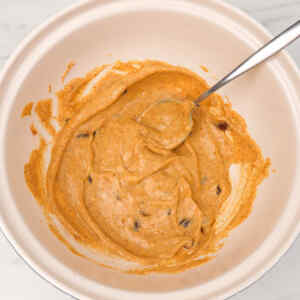 A creamy mixture in a bowl, likely a sauce or dressing for coronation chicken.