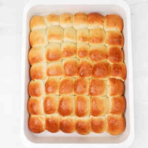 A tray of golden-brown garlic dough balls arranged in a grid pattern.