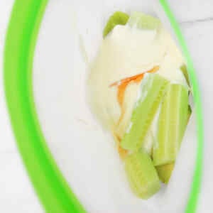Ingredients for a kiwi and avocado smoothie in a freezer bag.