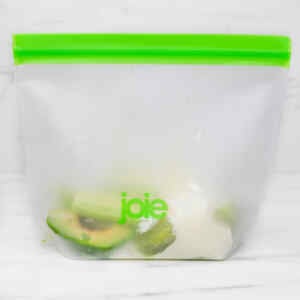 A clear bag containing kiwi and avocado smoothie ingredients, ready for freezer meal prep.