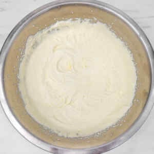 A bowl of creamy lemon ice cream mixture ready for freezing.