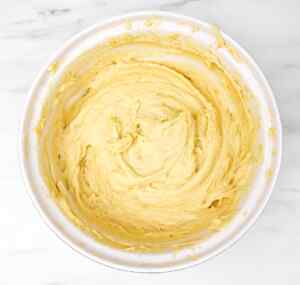 Bowl of creamy lemon cake batter ready for baking.