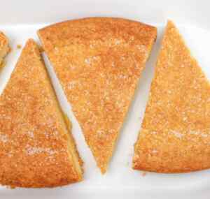 Slices of golden Scottish shortbread with a sprinkle of sugar on top.