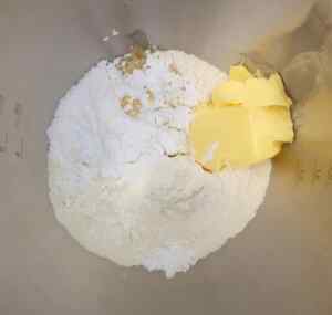 Ingredients for making Scottish shortbread, including flour and butter in a mixing bowl.
