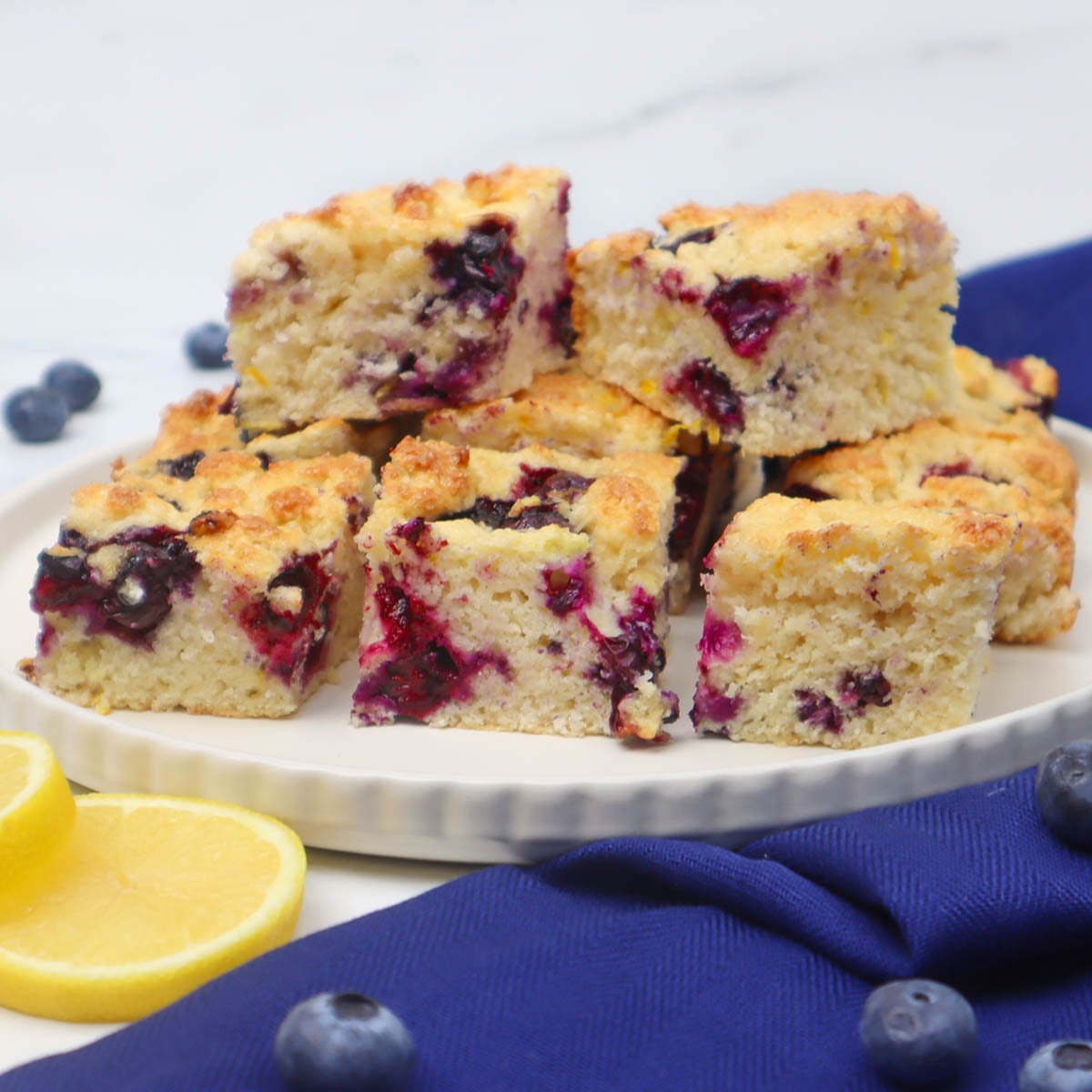 American Style Blueberry Biscuits A plate of American style blueberry biscuits with a golden crust and visible blueberries.