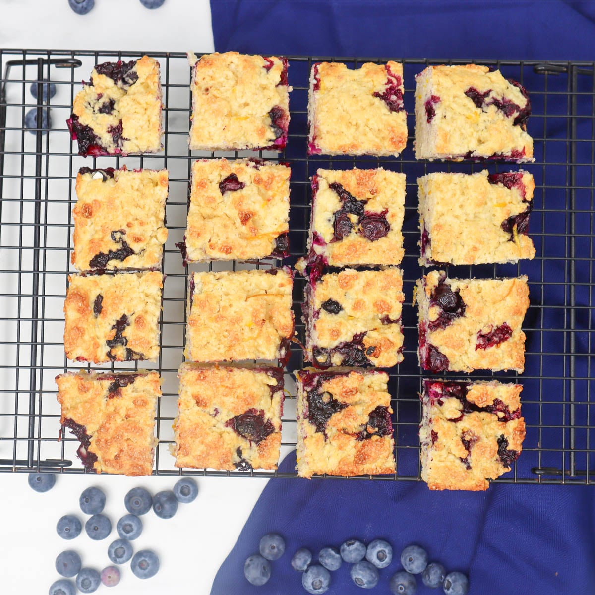 American Style Blueberry Biscuits Freshly baked blueberry biscuits arranged on a cooling rack.